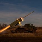 a military vehicle with a missile in the air