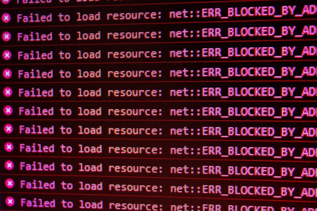 Red error messages on a black computer screen indicating blocked web resources