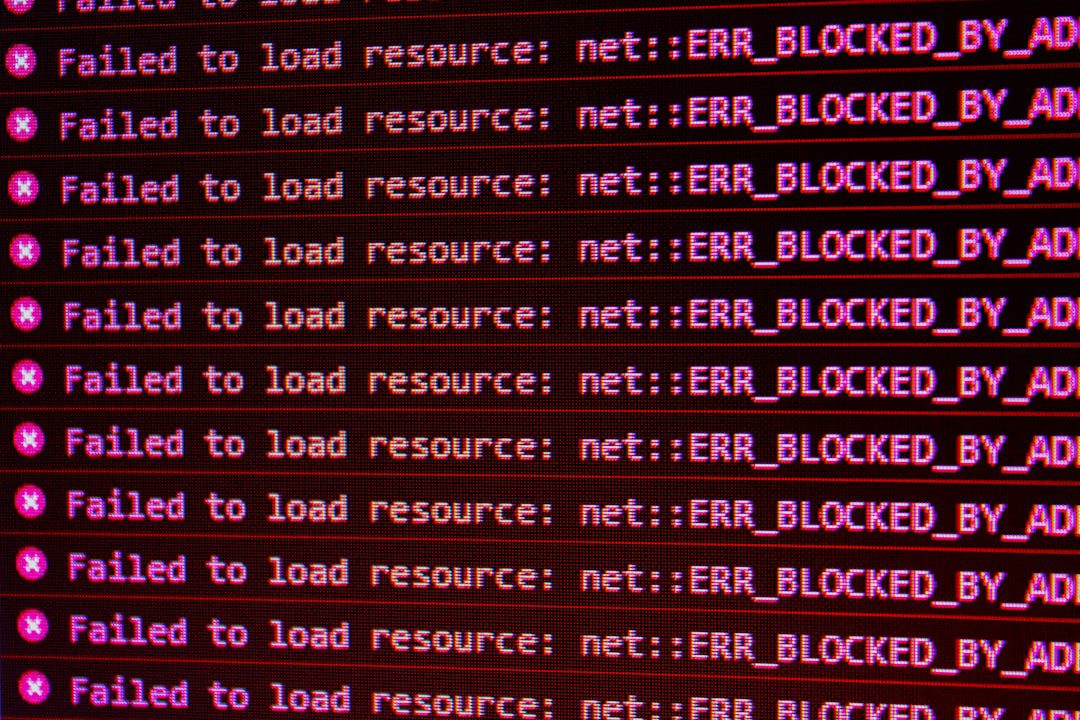 Red error messages on a black computer screen indicating blocked web resources