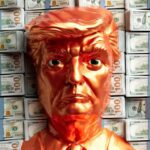 A golden trump head stands before stacks of money