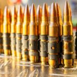 a bunch of bullet shells lined up on a table