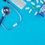 a stethoscope, pills, and a shopping cart on a blue background