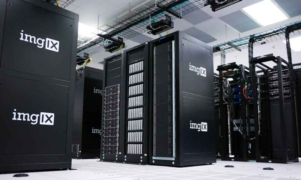 Rows of black server racks with white logos in a data center
