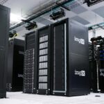 Rows of black server racks with white logos in a data center