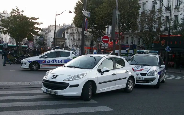 Véhicules de la police nationale stationnés dans une rue parisienne