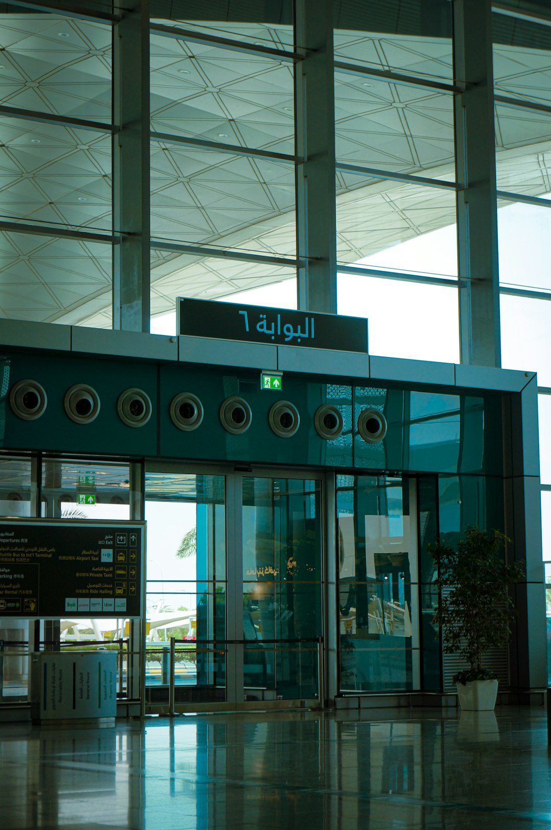 Modern airport interior with gate 6 sign and glass walls