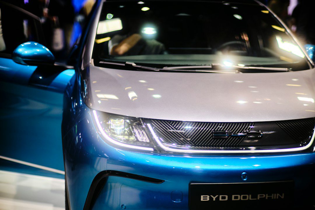 a close up of the front of a blue and white car