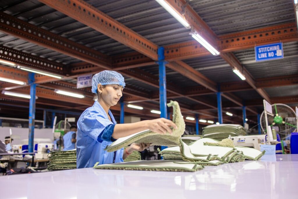 A worker folds fabric at a manufacturing facility
